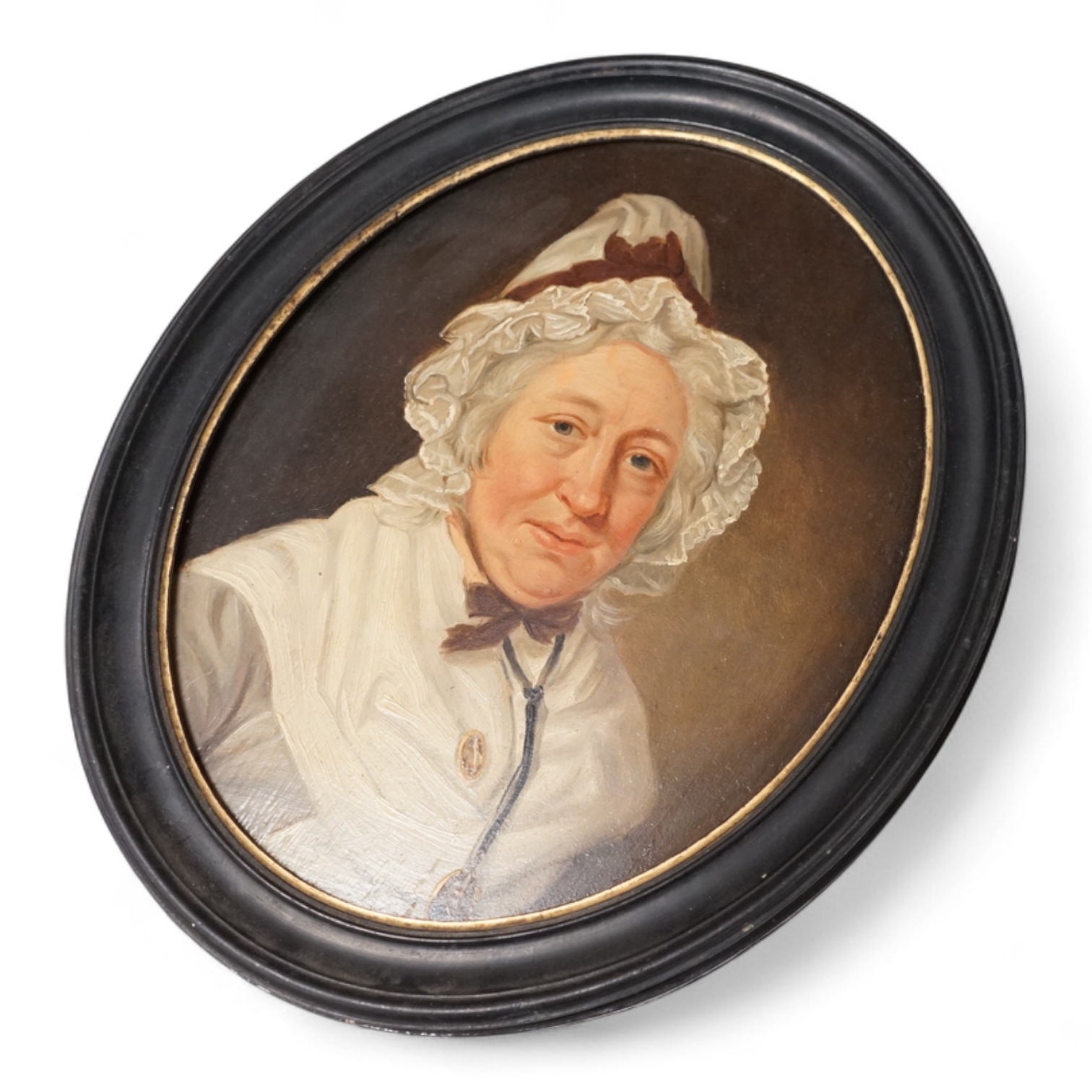 Georgian School, portrait of a lady wearing a bonnet, unsigned, oval oil on panel, 26 x 20cm, housed in an ebonised frame